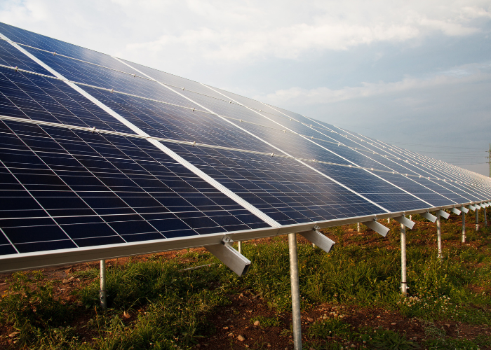 Residential solar panels generating electricity to charge a Tesla EV