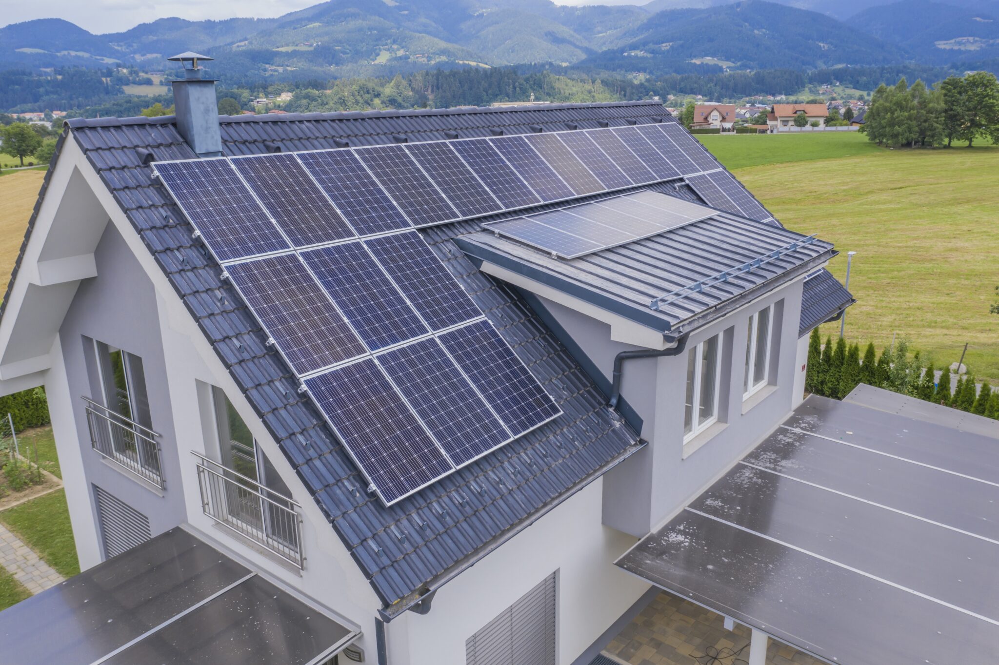 Technician installing solar panels on house roof for residential solar energy system
