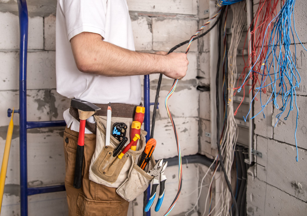 Electrician inspecting upgraded switchboard for improved electrical safety
