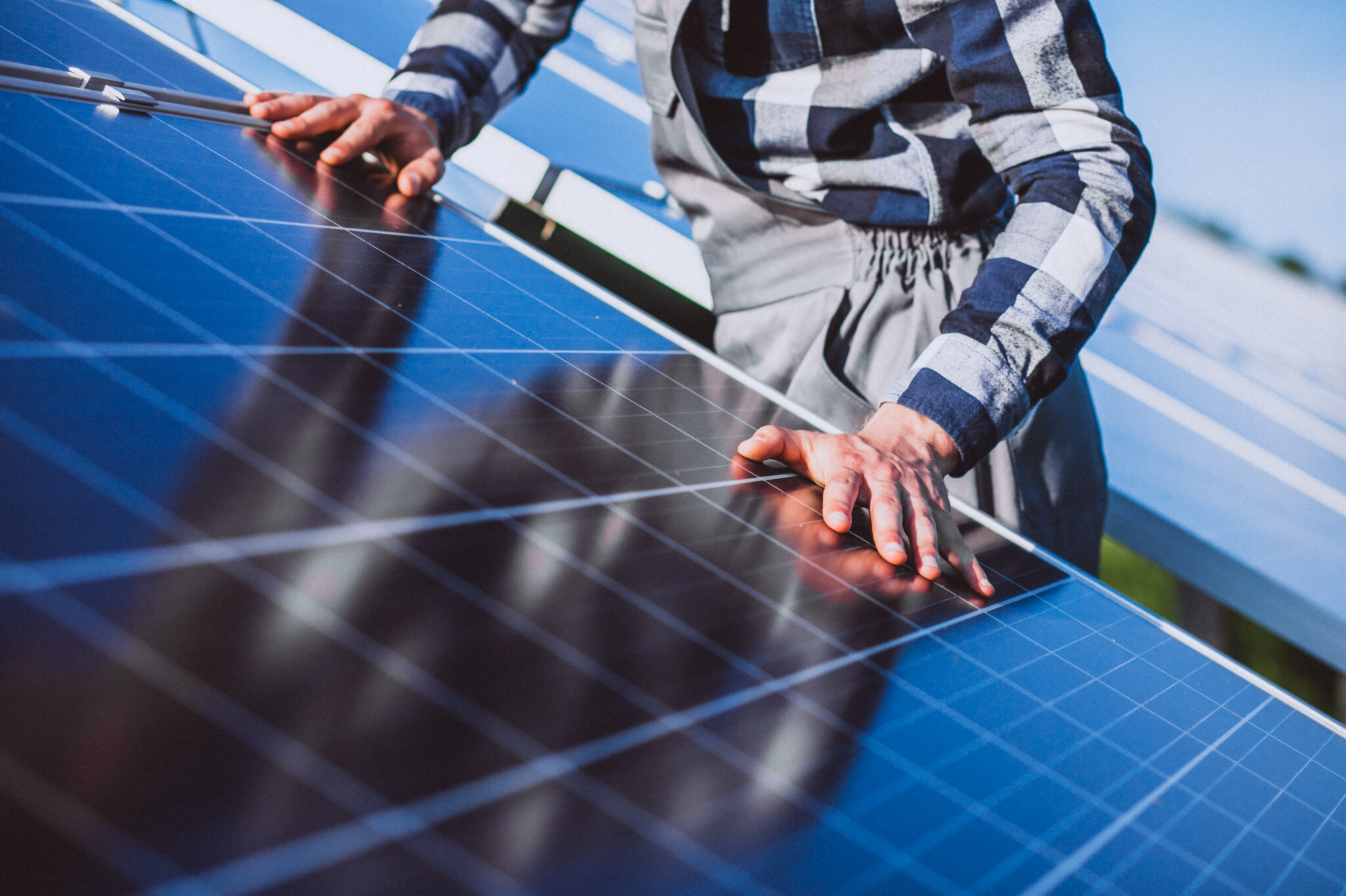 Technician carrying out preventative maintenance on a solar panel system