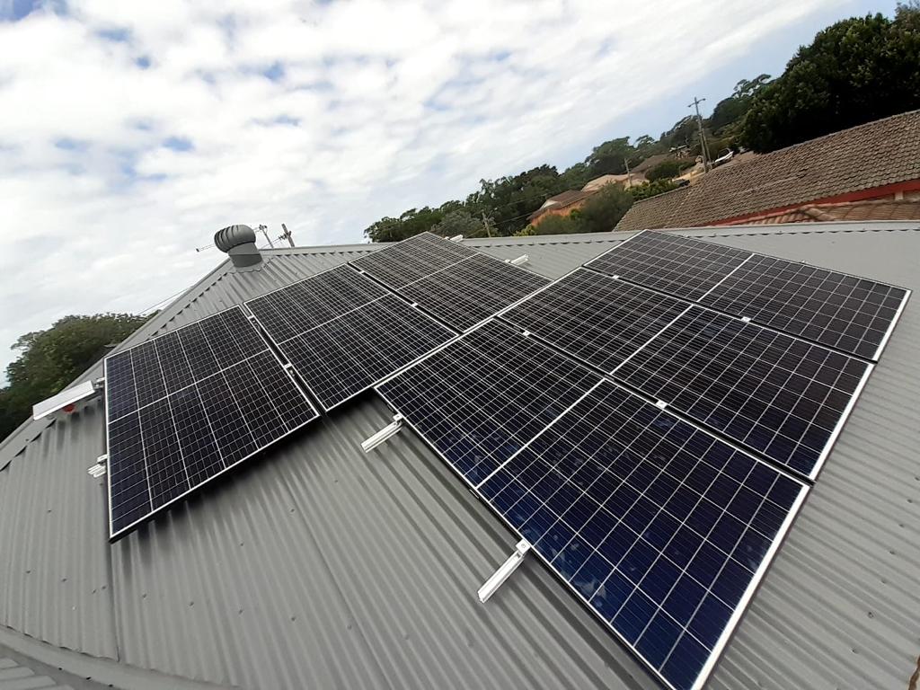 Real estate property with rooftop solar panels highlighting sustainable home improvements