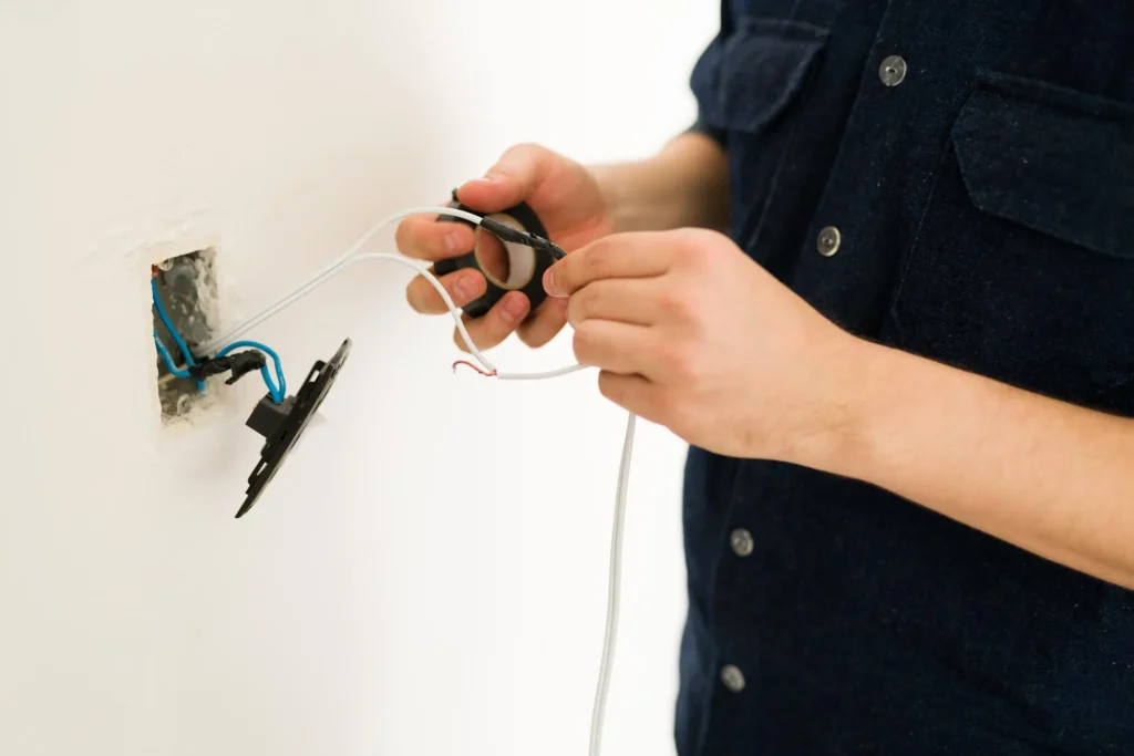 Electrician connecting wires for solar installation in Sydney residential setting