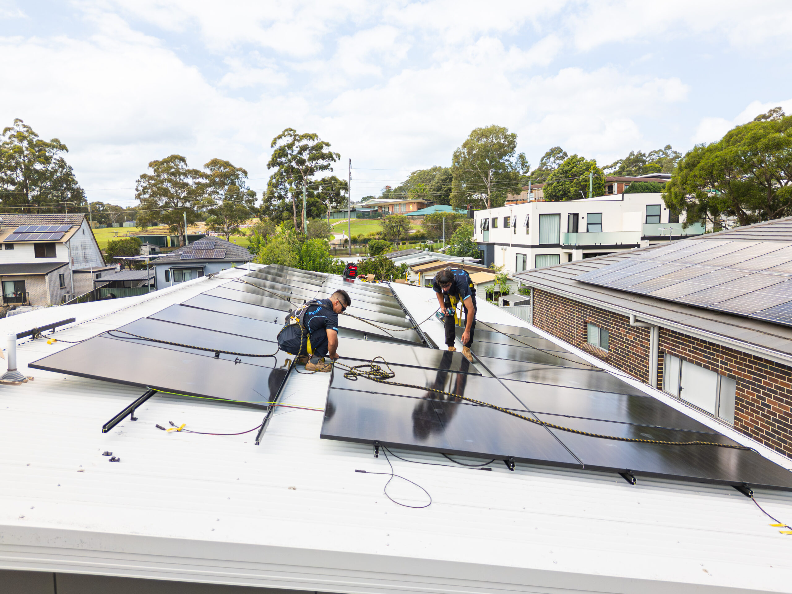 Solar installers working on roof panels in Sydney for Charlie Sparks.
