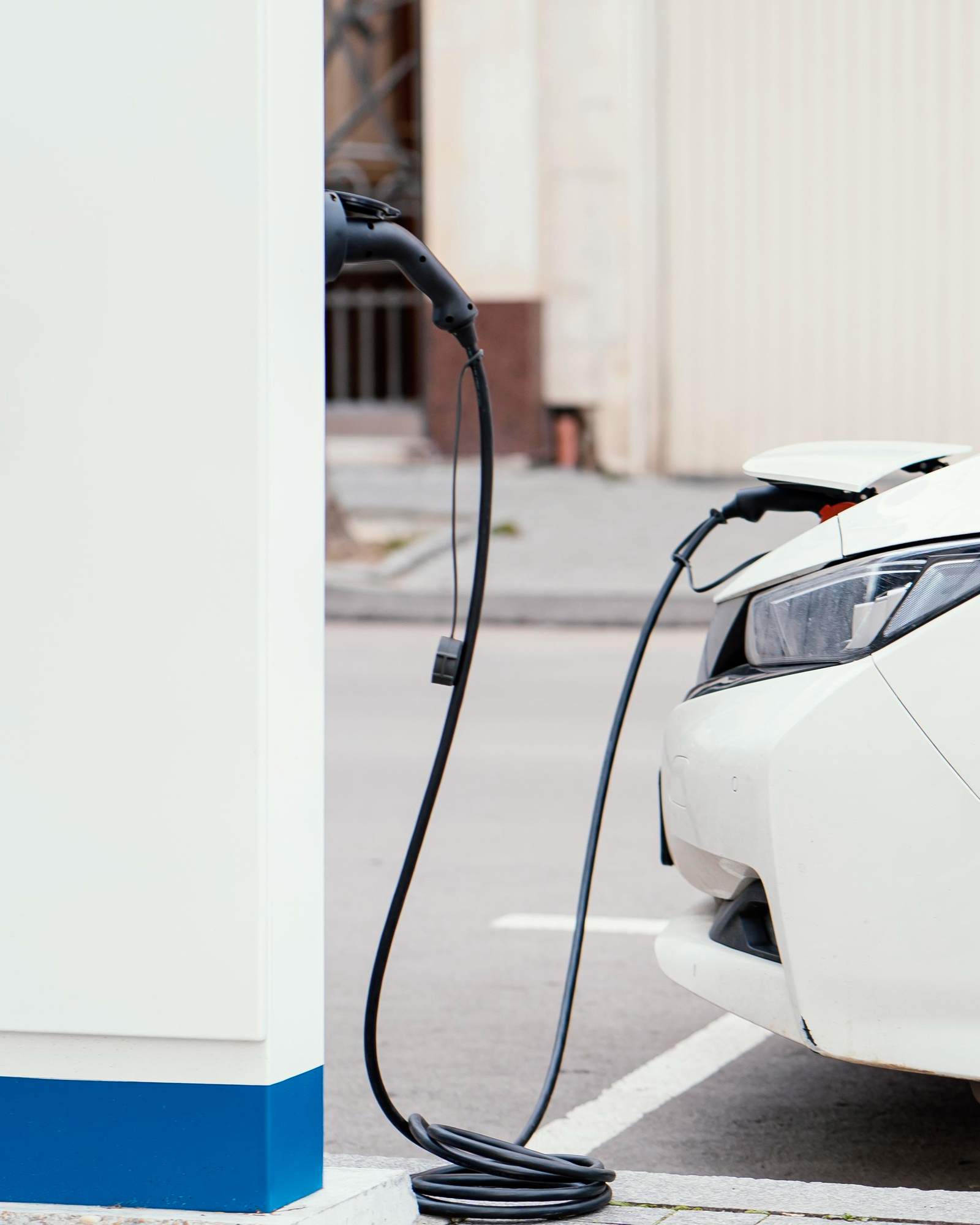EV charger connected to a car, showcasing professional installation services in Sydney.