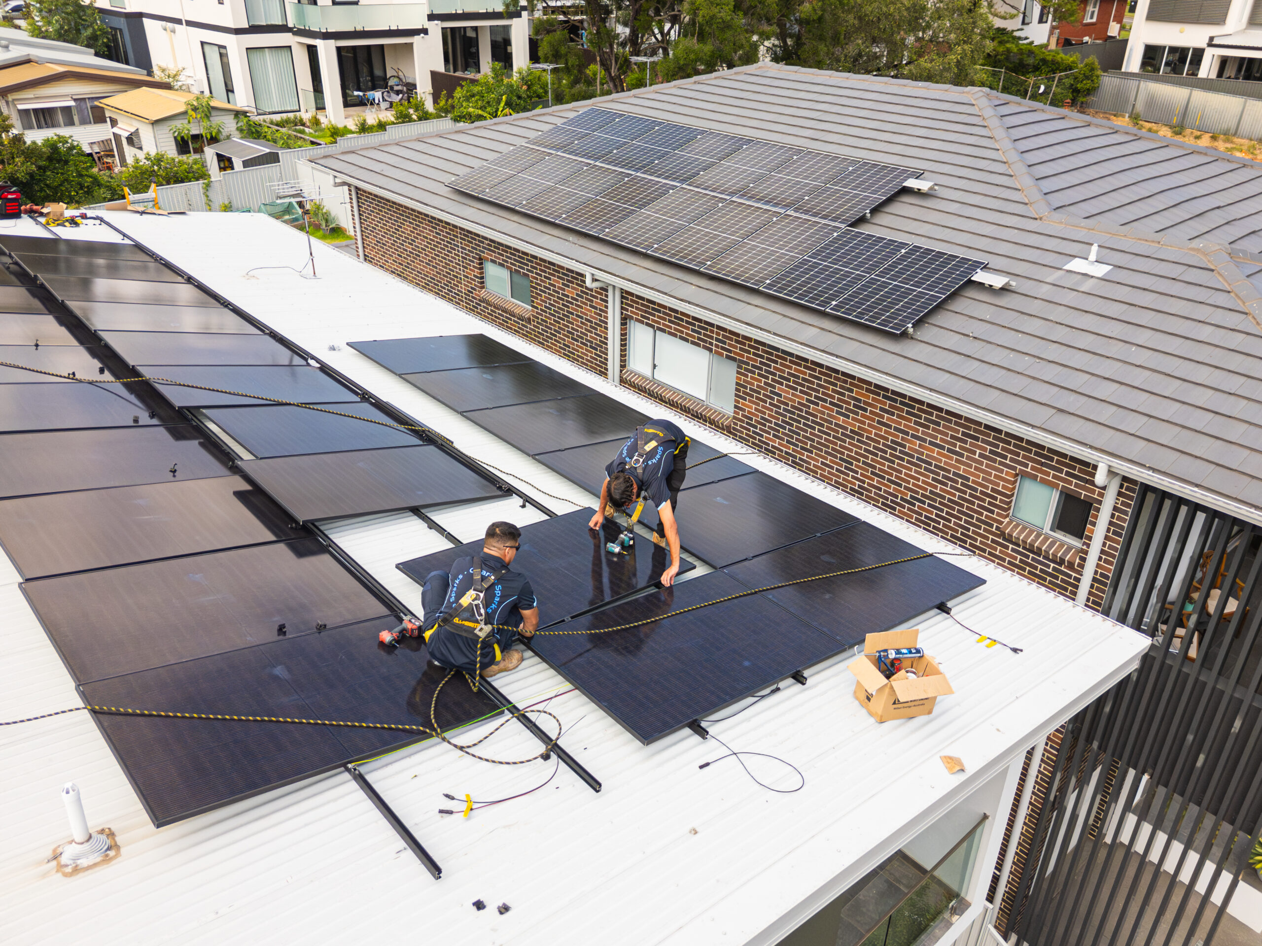 Charlie Sparks technicians installing solar panels on Sydney rooftops.