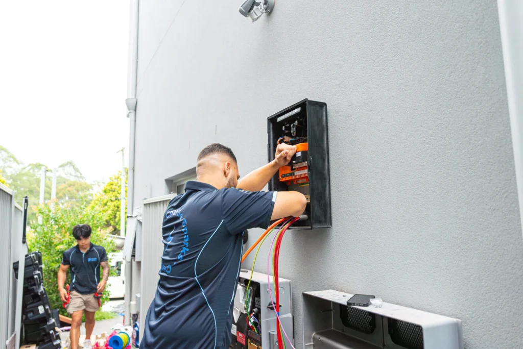 Qualified solar installer connecting electrical services in Sydney home.
