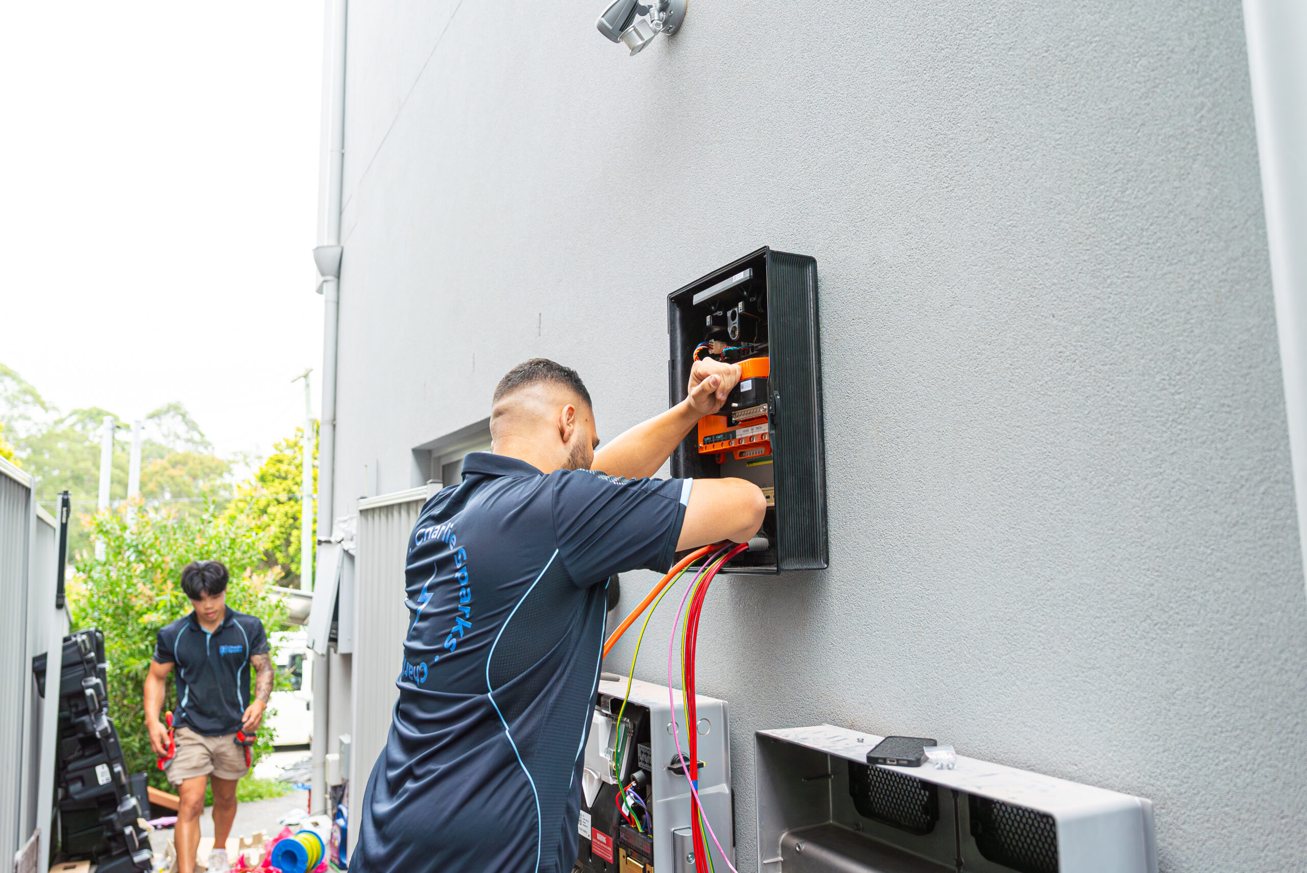Qualified solar installer connecting electrical services in Sydney home.
