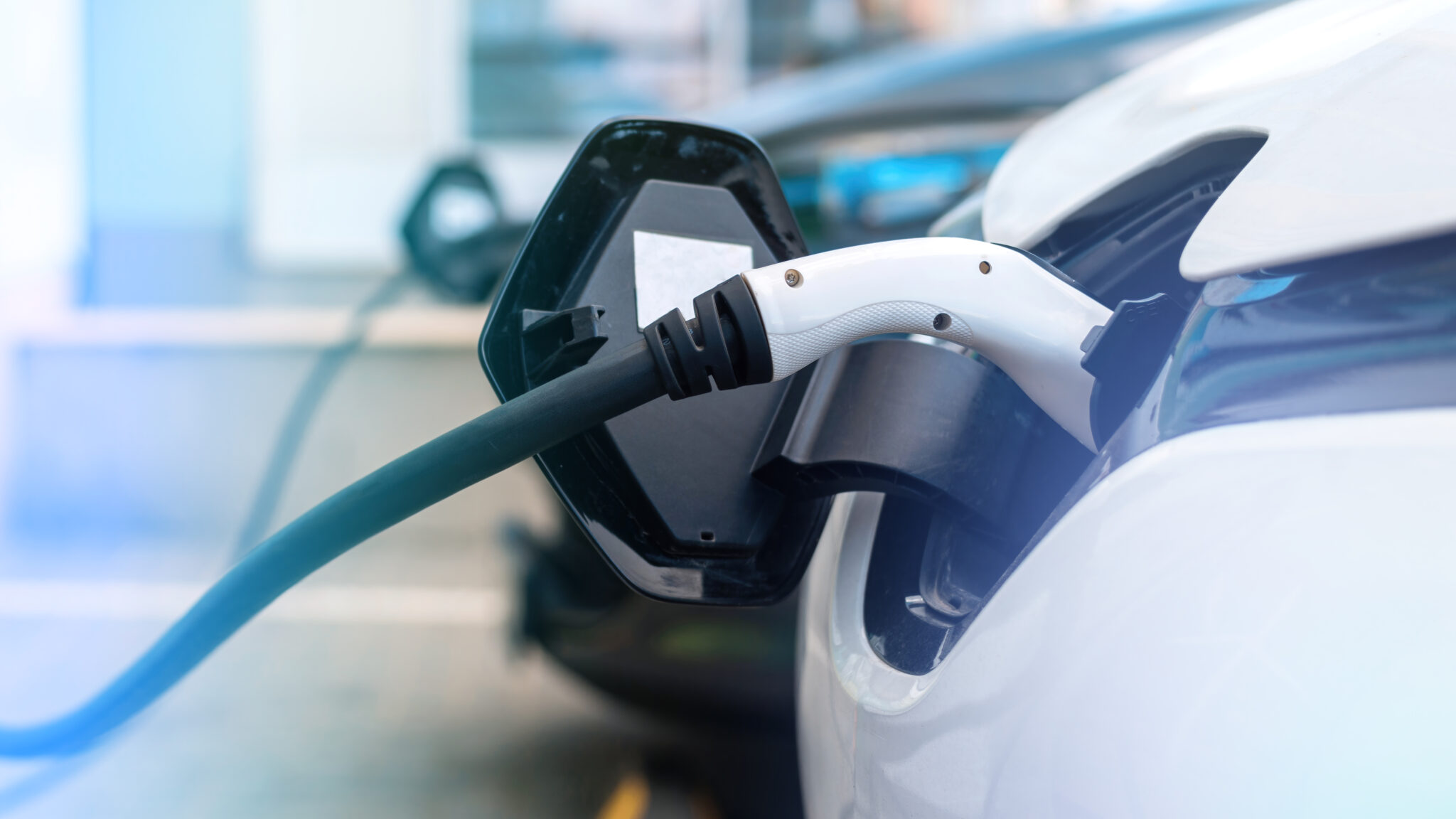 Electric vehicles plugged into charge stations showing growing EV charging demand